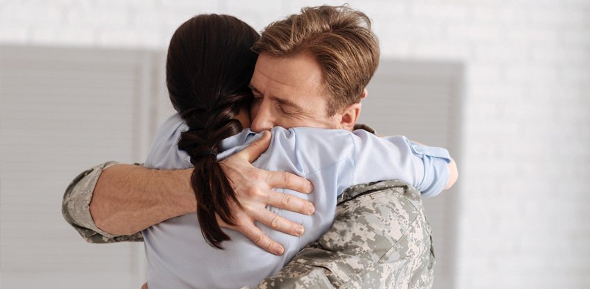 Stock image of a man and woman hugging