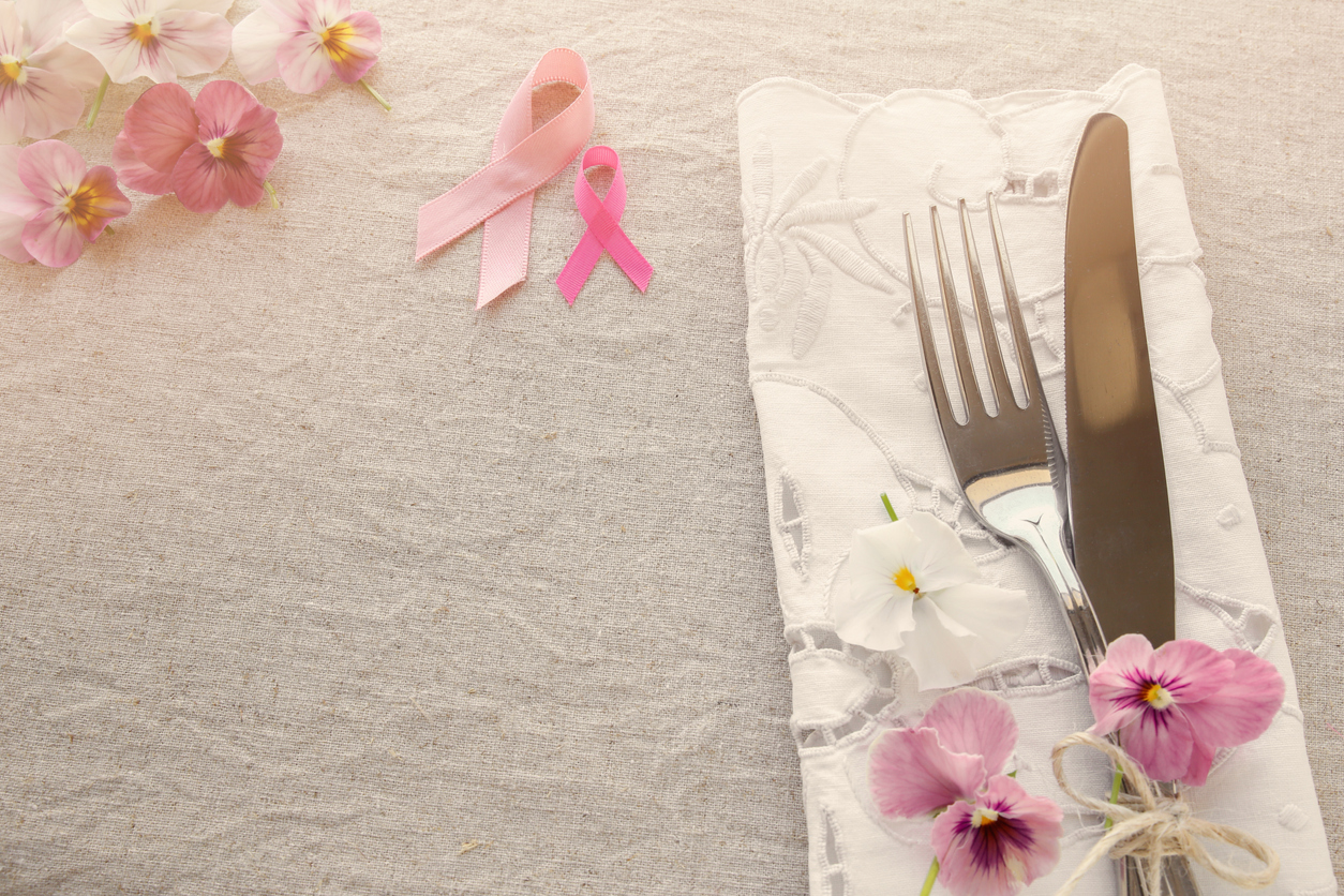 Pink ribbon on dining table for breast cancer fighting foods